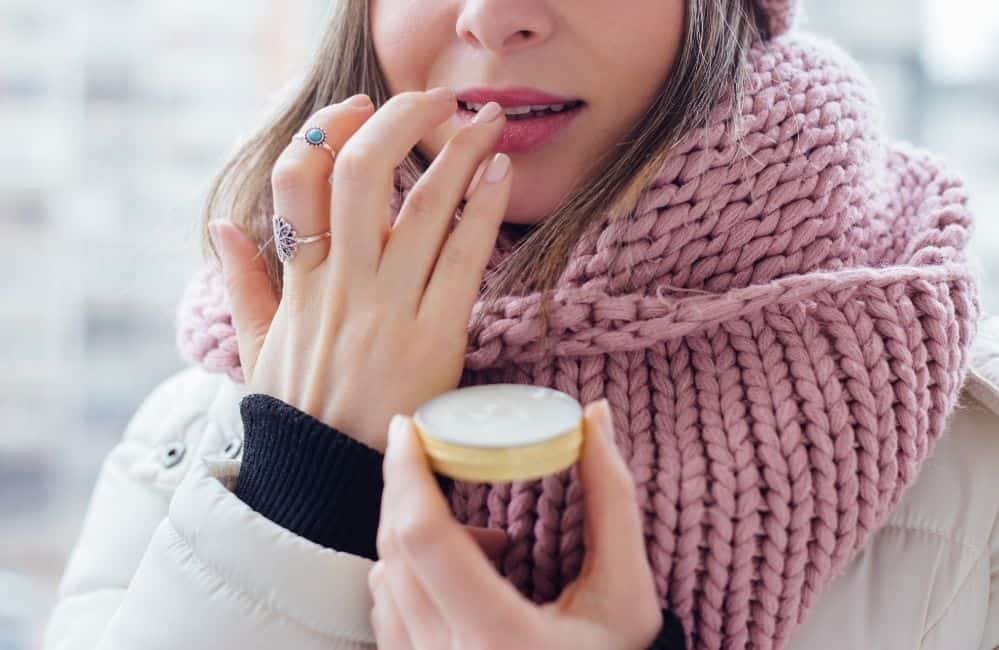 woman using lip balm, lip balm for dry skin in winters